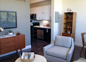 Thumbnail 23 of 36 - Open concept living space with kitchen and seating at 68 Beale Apartments, Quincy, MA 02169